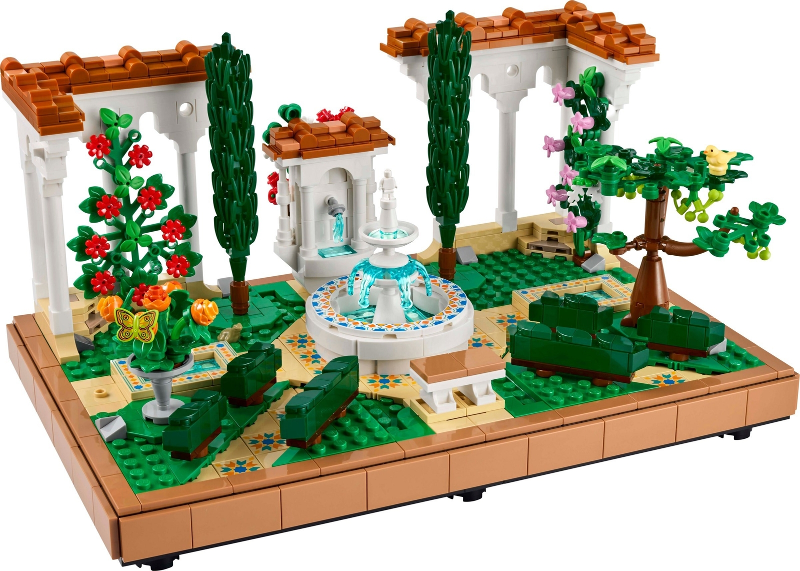 LEGO garden scene with a fountain, flowers, and trees on a white background