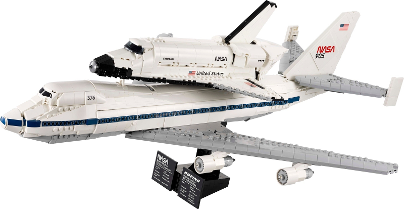 Model of a space shuttle on an airplane with NASA branding on a white background