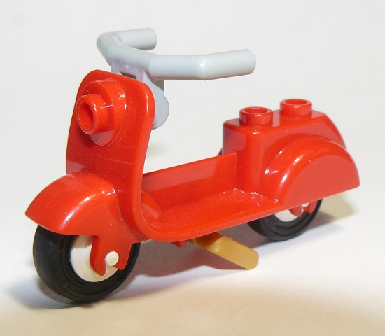 Display of LEGO part no. 15396c01 which is a Red Scooter with Pearl Gold Stand, Light Bluish Gray Angular Handlebars, and White Wheels 
