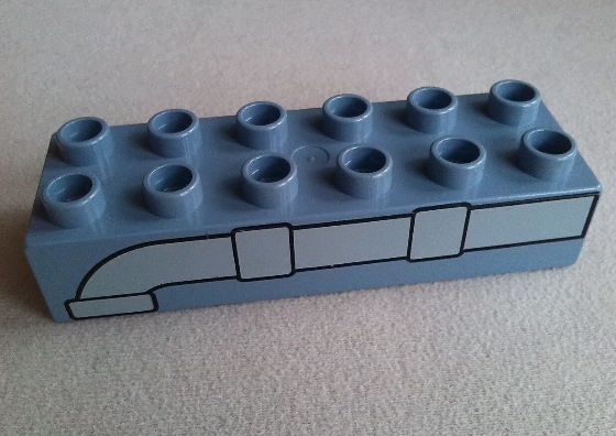 Display of LEGO part no. 2300pb003 which is a Sand Blue Duplo, Brick 2 x 6 with Pipe Pattern 
