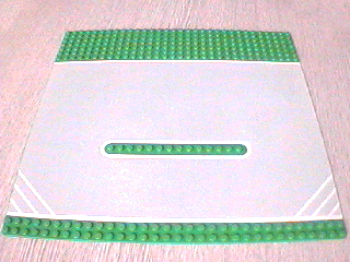 Display of LEGO part no. 30030pb01 which is a Green Baseplate, Road 32 x 32 Racing with White Outlines and Corner Hashmarks Pattern 