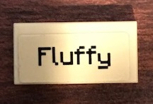Display of LEGO part no. 3069pb0741 which is a Tan Tile 1 x 2 with 'Fluffy' Pattern (Sticker), Set 21144 