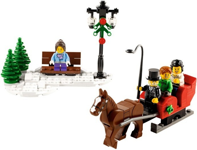 LEGO set with a horse-drawn carriage, bench, and Christmas tree on a white background