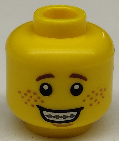 Display of LEGO part no. 3626cpb1177 which is a Yellow Minifigure, Head Open Mouth Smile with Teeth and Braces, Freckles Pattern, Hollow Stud 