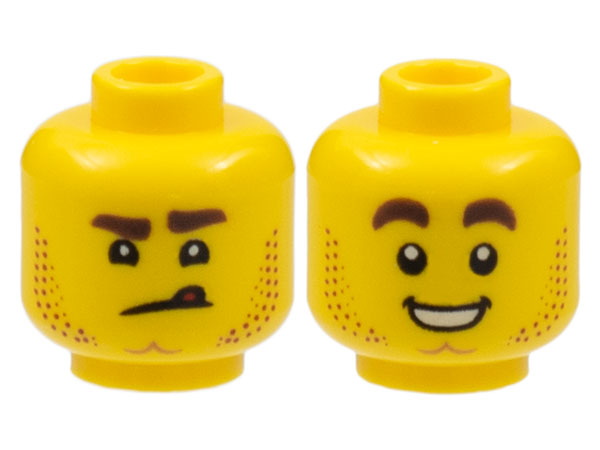Display of LEGO part no. 3626pb2460 which is a Yellow Minifigure, Head Dual Sided Stubble, Dimpled Chin, Angry Scowl with Tongue / Smile with Teeth Pattern 