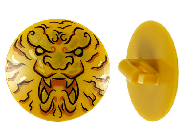 Display of LEGO part no. 75902pb17 which is a Pearl Gold Minifigure, Shield Circular / Round Convex Face with Black and Gold Ninjago Lion Head Pattern 