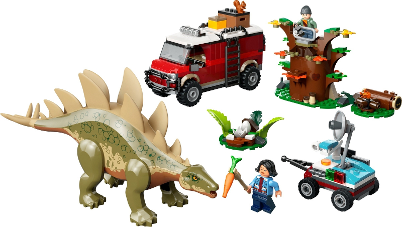 Collection of toy figures and vehicles including a dinosaur, truck, and people on a white background