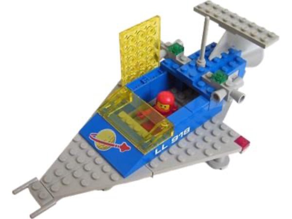 Toy spaceship model with a small figure inside on a white background