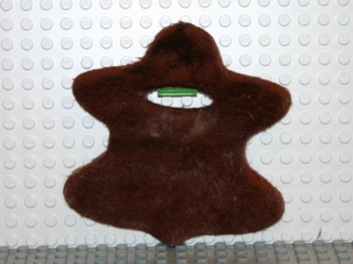 Display of LEGO part no. x1870 which is a Dark Brown Duplo Wear Cloth Bearskin with Neck Opening 