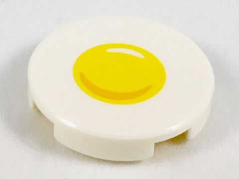 Display of LEGO part no. 14769pb210 Tile, Round 2 x 2 with Bottom Stud Holder with Sunny Side Up Egg Pattern  which is a White Tile, Round 2 x 2 with Bottom Stud Holder with Sunny Side Up Egg Pattern 