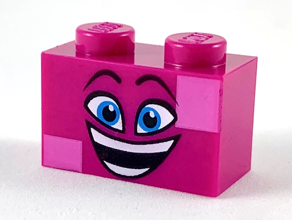 Display of LEGO part no. 3004pb186 Brick 1 x 2 with Dark Azure Eyes, Raised Eyebrows, Wide Open Smile and Dark Pink Squares on Two Corners Pattern (Queen Watevra Wa'Nabi Face)  which is a Magenta Brick 1 x 2 with Dark Azure Eyes, Raised Eyebrows, Wide Open Smile and Dark Pink Squares on Two Corners Pattern (Queen Watevra Wa'Nabi Face) 