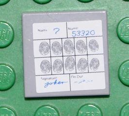 Display of LEGO part no. 3068bpb0159 Tile 2 x 2 with Groove with Fingerprints File Joker Pattern (Sticker), Set 7783  which is a Light Bluish Gray Tile 2 x 2 with Groove with Fingerprints File Joker Pattern (Sticker), Set 7783 