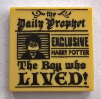 Display of LEGO part no. 3068bpb1156 Tile 2 x 2 with Groove with 'the Daily Prophet, EXCLUSIVE HARRY POTTER, The Boy who LIVED!' and Image of Boy with Glasses Pattern  which is a Tan Tile 2 x 2 with Groove with 'the Daily Prophet, EXCLUSIVE HARRY POTTER, The Boy who LIVED!' and Image of Boy with Glasses Pattern 