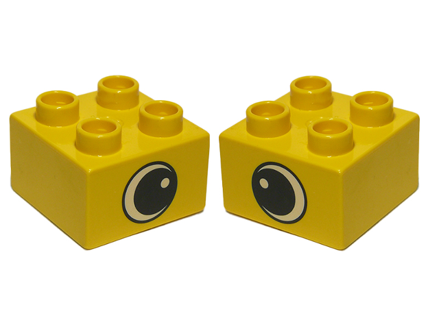 Display of LEGO part no. 3437pe1 Duplo, Brick 2 x 2 with Black and White Eye with Spot Pattern on Opposite Sides  which is a Yellow Duplo, Brick 2 x 2 with Black and White Eye with Spot Pattern on Opposite Sides 