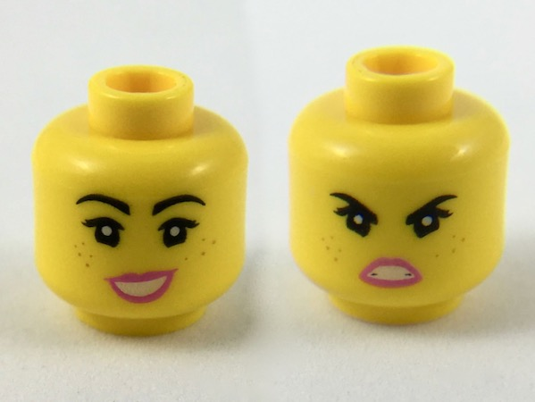 Display of LEGO part no. 3626cpb2263 Minifigure, Head Dual Sided Female Black Eyebrows, Freckles, Eyelashes, Pink Lips, Open Mouth Smile with Wide Top / Angry Pattern (Lucy), Hollow Stud  which is a Yellow Minifigure, Head Dual Sided Female Black Eyebrows, Freckles, Eyelashes, Pink Lips, Open Mouth Smile with Wide Top / Angry Pattern (Lucy), Hollow Stud 