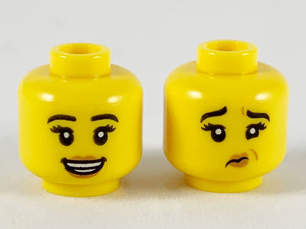 Display of LEGO part no. 3626cpb2467 Minifigure, Head Dual Sided Female, Black Eyebrows, Medium Nougat Lips, Smile / Grossed Out Pattern, Hollow Stud  which is a Yellow Minifigure, Head Dual Sided Female, Black Eyebrows, Medium Nougat Lips, Smile / Grossed Out Pattern, Hollow Stud 