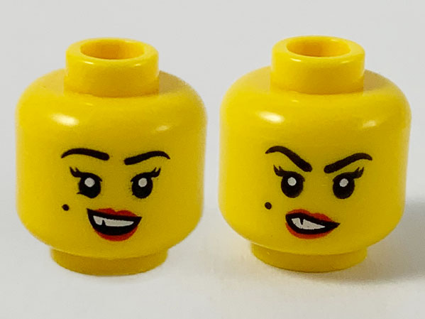 Display of LEGO part no. 3626cpb2605 Minifigure, Head Dual Sided Female, Black Eyebrows and Beauty Mark on Right Cheek, Red Lips and Chipped Tooth, Smile / Sneer Pattern, Hollow Stud  which is a Yellow Minifigure, Head Dual Sided Female, Black Eyebrows and Beauty Mark on Right Cheek, Red Lips and Chipped Tooth, Smile / Sneer Pattern, Hollow Stud 