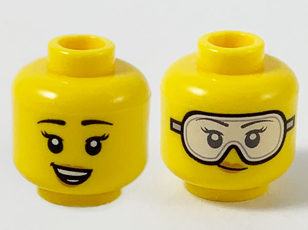 Display of LEGO part no. 3626cpb2606 Minifigure, Head Dual Sided Female, Black Eyebrows, Peach Lips, Smile Showing Teeth / Safety Goggles Pattern, Hollow Stud  which is a Yellow Minifigure, Head Dual Sided Female, Black Eyebrows, Peach Lips, Smile Showing Teeth / Safety Goggles Pattern, Hollow Stud 