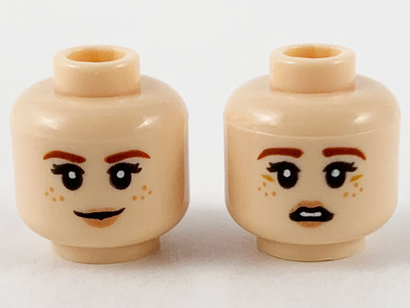 Display of LEGO part no. 3626cpb2672 Minifigure, Head Dual Sided Female, Reddish Brown Eyebrows, Medium Nougat Freckles, Peach Lips, Grin / Scared Pattern, Hollow Stud  which is a Light Nougat Minifigure, Head Dual Sided Female, Reddish Brown Eyebrows, Medium Nougat Freckles, Peach Lips, Grin / Scared Pattern, Hollow Stud 
