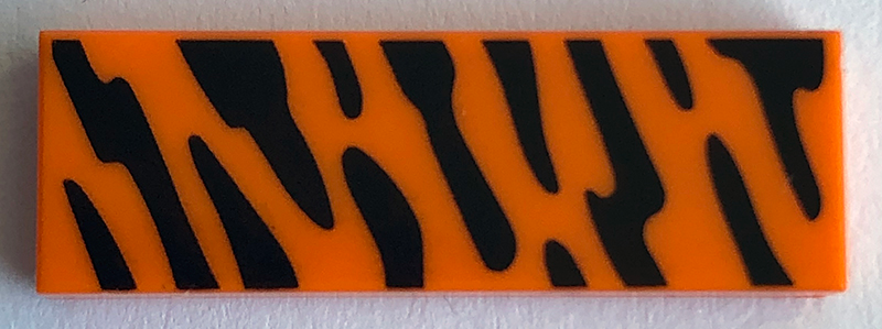 Display of LEGO part no. 63864pb079 Tile 1 x 3 with Animal Print (Black Stripes) Pattern  which is a Orange Tile 1 x 3 with Animal Print (Black Stripes) Pattern 