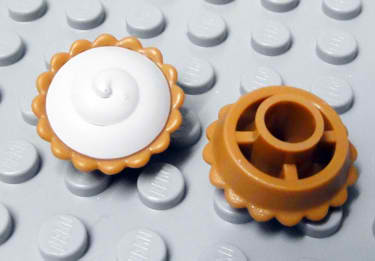 Display of LEGO part no. 93568pb001 which is a Medium Nougat Pie with White Cream Filling Pattern 