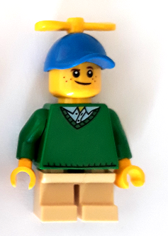 Display of LEGO Holiday & Event Boy, Freckles, Green Sweater, Tan Short Legs, Blue Cap with Tiny Yellow Propeller