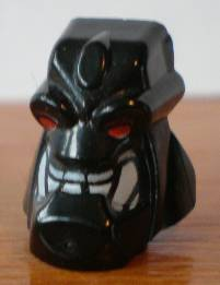 Display of LEGO part no. x1814px1 Minifigure, Head, Modified Bionicle Piraka Reidak with Eyes and Teeth Pattern  which is a Black Minifigure, Head, Modified Bionicle Piraka Reidak with Eyes and Teeth Pattern 